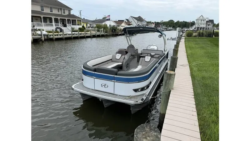 Slide: The Image of 2023 Avalon 2585 VRB pontoon boat docked on a calm canal. - 21