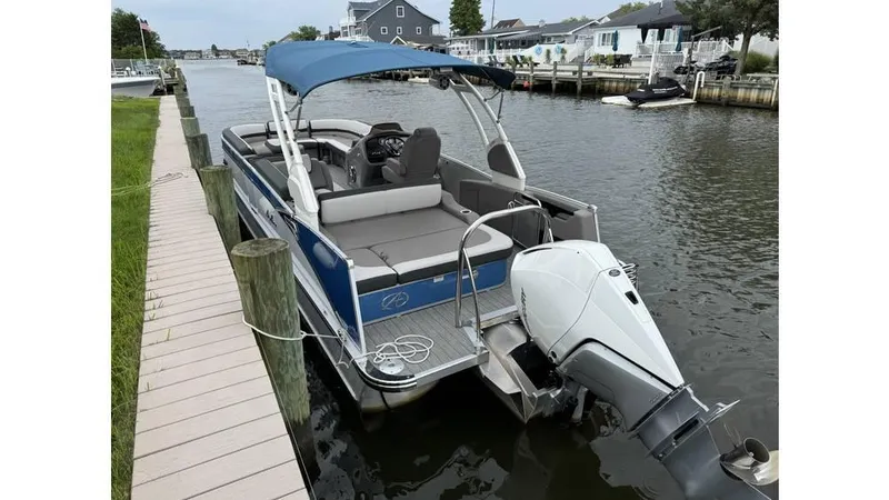 Slide: The Image of 2023 Avalon 2585 VRB pontoon boat docked on a calm canal. - 22