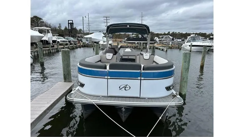 Slide: The Image of 2023 Avalon 2585 VRB pontoon boat docked in a marina, overcast sky. - 3
