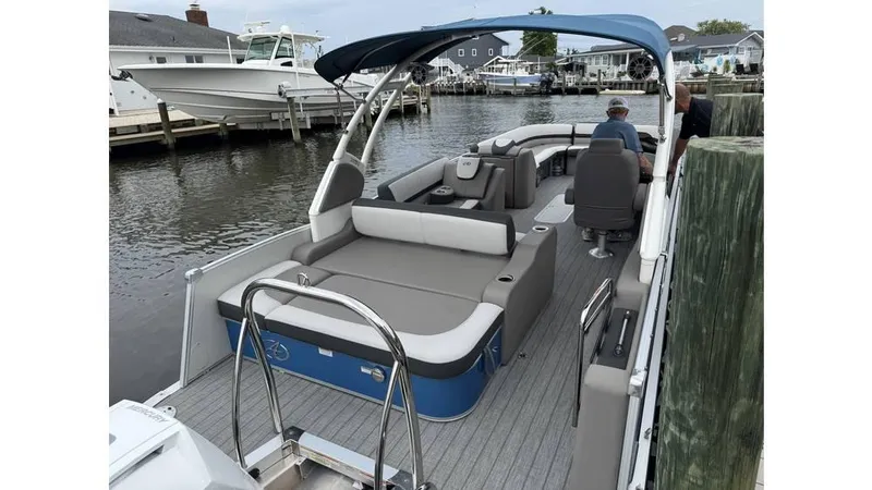 Slide: The Image of 2023 Avalon 2585 VRB pontoon boat docked, featuring spacious seating and canopy. - 6