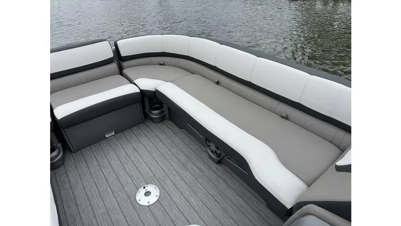 Slide: The Image of 2023 Avalon 2585 VRB boat interior with gray seating and flooring, near water. - 9