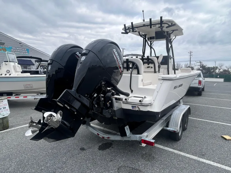Slide: The Image of 2024 Sea Born LX24 LE boat with dual Mercury engines on a trailer. - 16