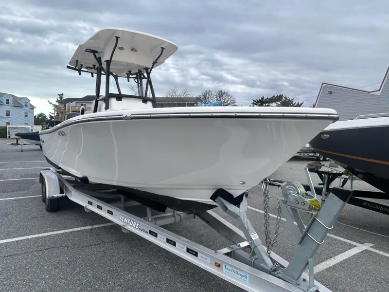 Slide: The Image of 2024 Sea Born LX24 LE boat on trailer in parking lot. - 3