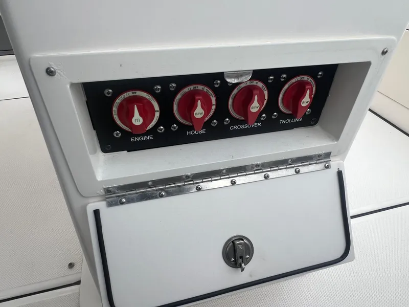 Slide: The Image of 2024 Sea Born LX24 LE boat control panel with engine, house, crossover, and trolling switches. - 8