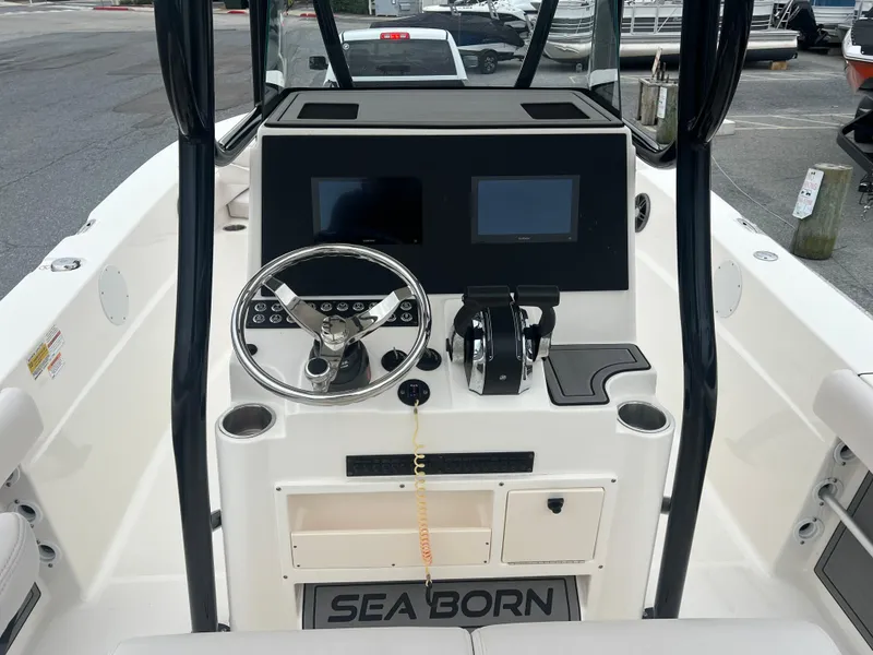 Slide: The Image of 2024 Sea Born LX24 LE boat dashboard with steering wheel and dual screens. - 9