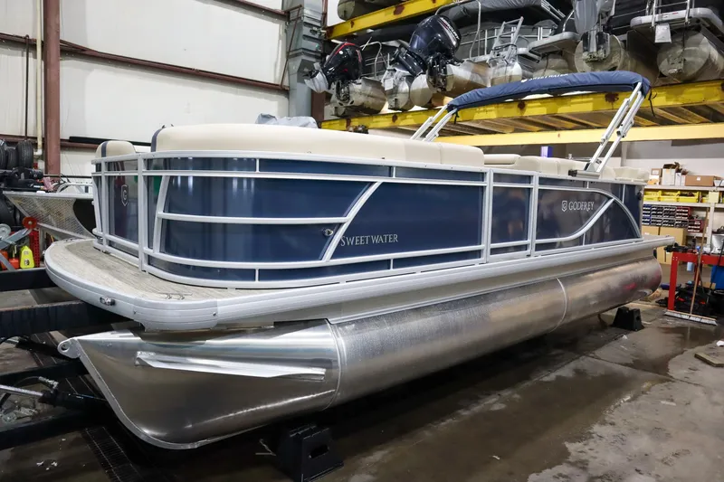Slide: The Image of 2025 Godfrey Sweetwater 2086 C pontoon boat in a storage facility. - 1