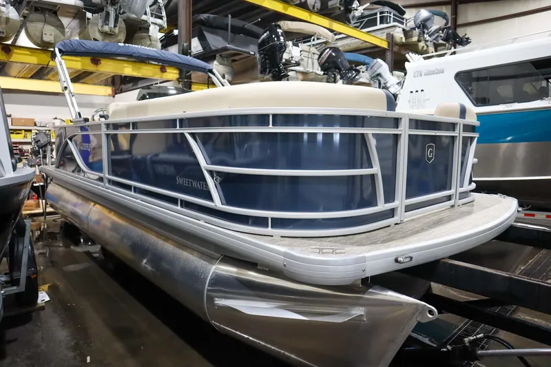 Slide: The Image of 2025 Godfrey Sweetwater 2086 C pontoon boat in a showroom setting. - 2