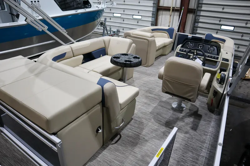 Slide: The Image of 2025 Godfrey Sweetwater 2086 C pontoon boat interior with beige seating and modern dashboard. - 5