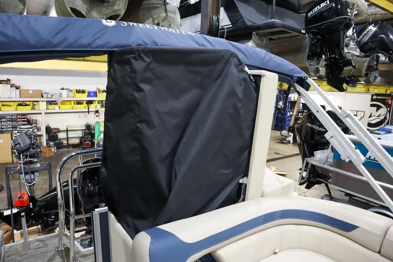 Slide: The Image of 2025 Godfrey Sweetwater 2086 C boat interior with protective cover in a workshop setting. - 6