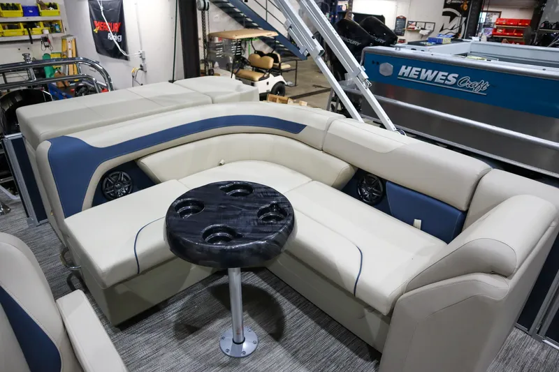 Slide: The Image of 2025 Godfrey Sweetwater 2086 C pontoon boat interior with plush seating and round table. - 7