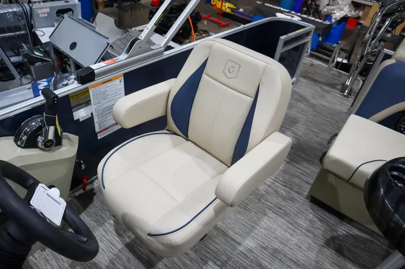 Slide: The Image of 2025 Godfrey Sweetwater 2086 C boat seat, beige with blue accents, in a showroom setting. - 8