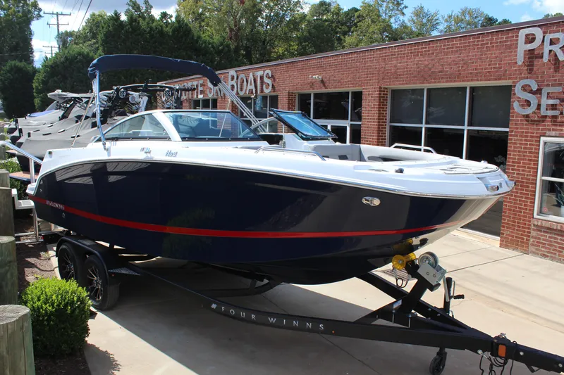 The Image of 2025 Four Winns HD3 boat on trailer outside dealership. - 1