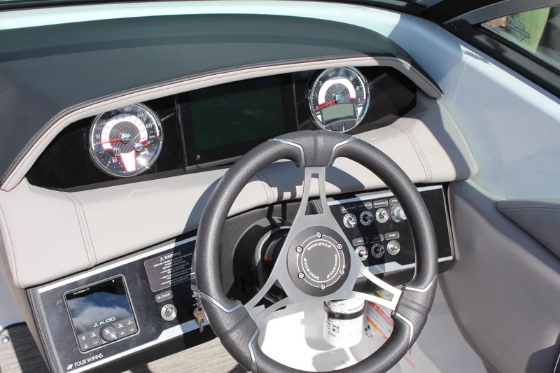 Slide: The Image of 2025 Four Winns HD3 boat dashboard with steering wheel and gauges. - 17