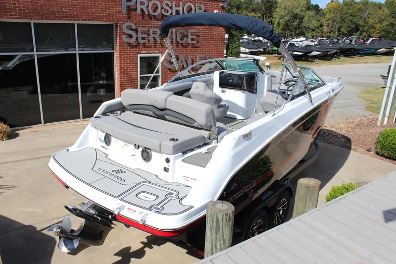 Slide: The Image of 2025 Four Winns HD3 boat at dealership, rear view, white exterior, modern design. - 3