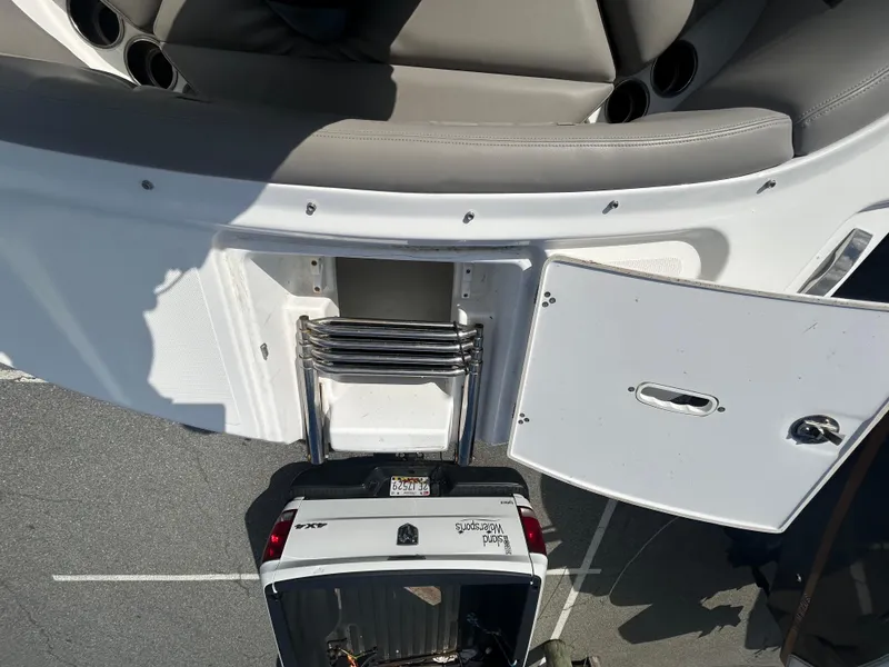 Slide: The Image of 2024 Four Winns HD5 OB boat with swim ladder and storage compartment. - 15