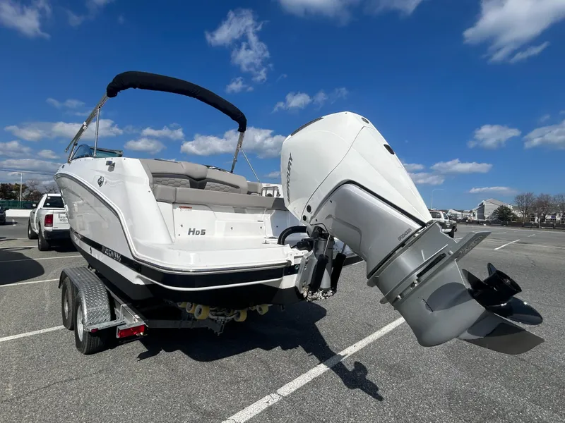 Slide: The Image of 2024 Four Winns HD5 OB boat on trailer under clear blue sky. - 16