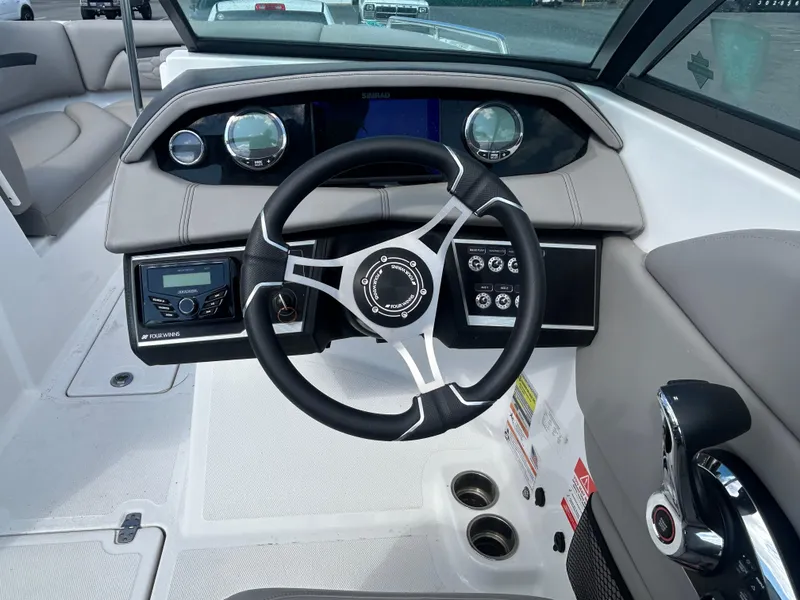 Slide: The Image of 2024 Four Winns HD5 OB boat dashboard with steering wheel and controls. - 9