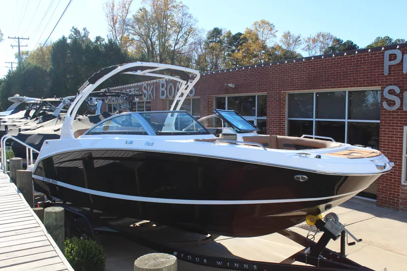 The Image of 2025 Four Winns HD3 boat displayed outside a dealership. - 1