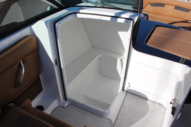 Slide: The Image of 2025 Four Winns HD3 boat storage compartment with sleek white interior and brown accents. - 10