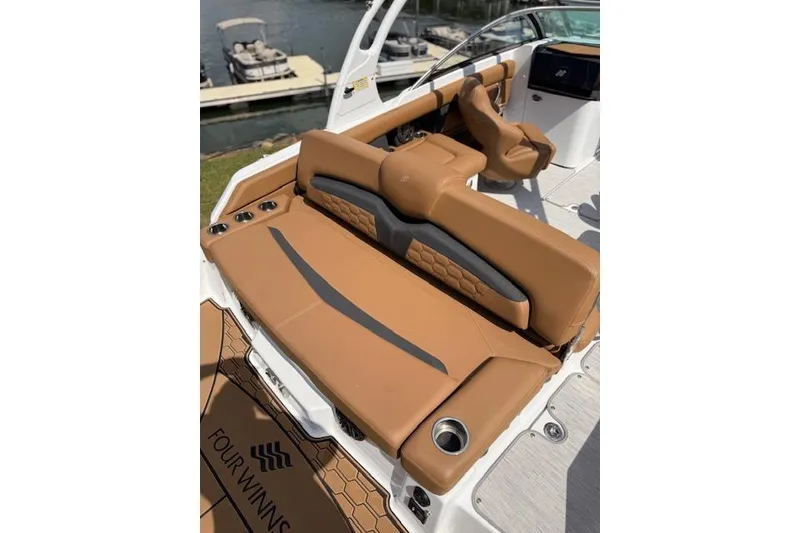 Slide: The Image of 2025 Four Winns HD3 boat interior with tan leather seating and modern design. - 14