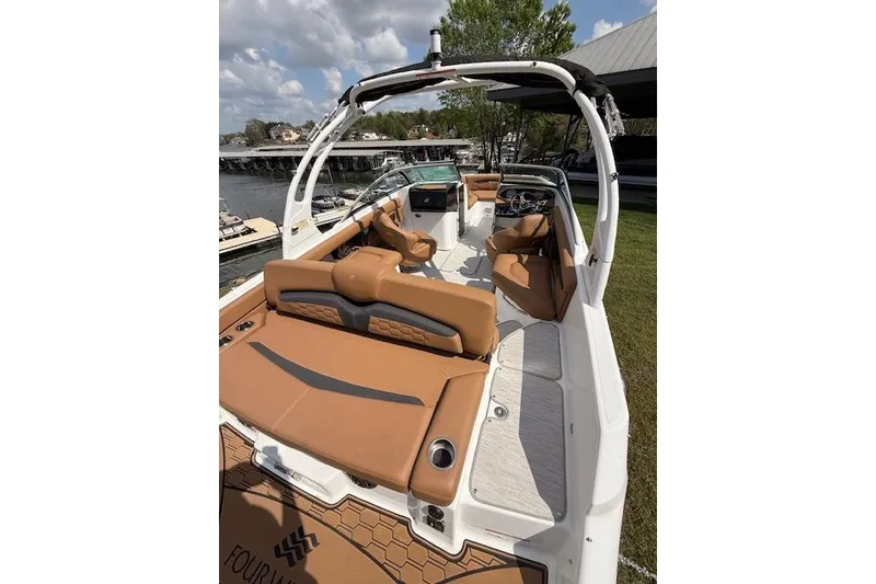 Slide: The Image of 2025 Four Winns HD3 boat with tan seating, sleek design, and spacious deck. - 16