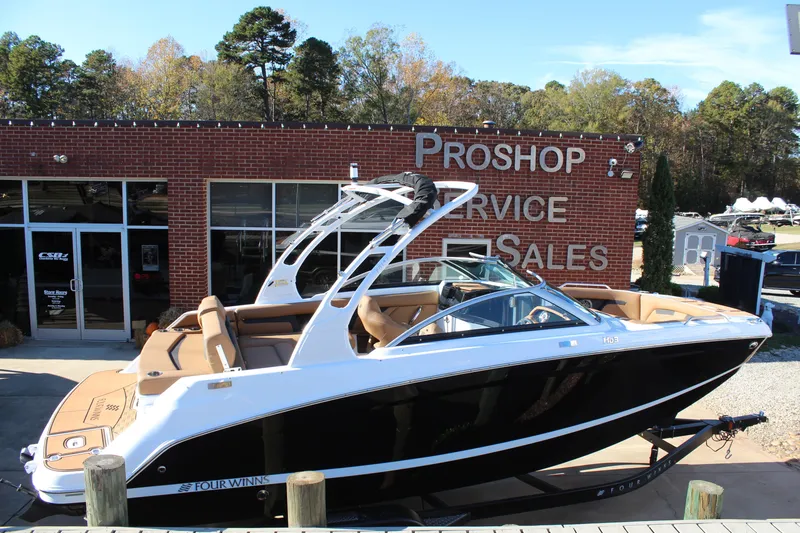 Slide: The Image of 2025 Four Winns HD3 boat displayed at a pro shop, ready for sale. - 5