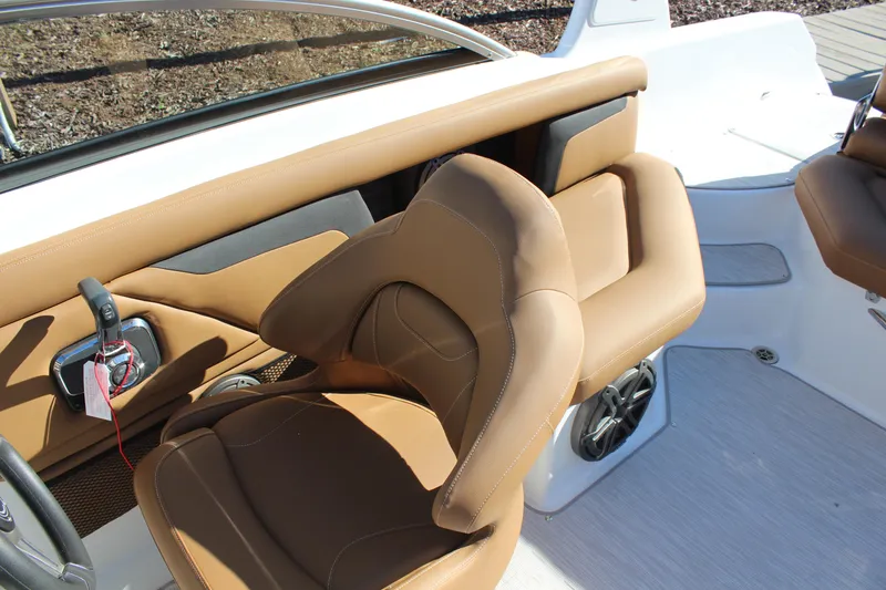 Slide: The Image of 2025 Four Winns HD3 boat interior with tan seating and modern controls. - 8
