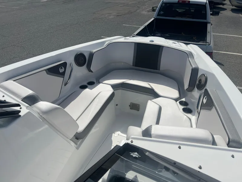 Slide: The Image of 2024 Scarab 255 ID boat interior with white seating and cup holders. - 12