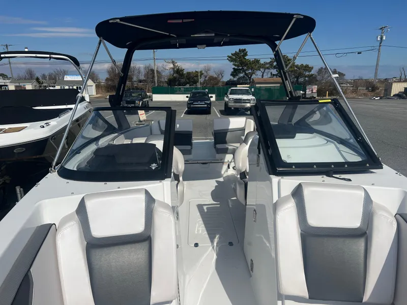 Slide: The Image of 2024 Scarab 255 ID boat with sleek design and spacious seating, docked outdoors. - 13