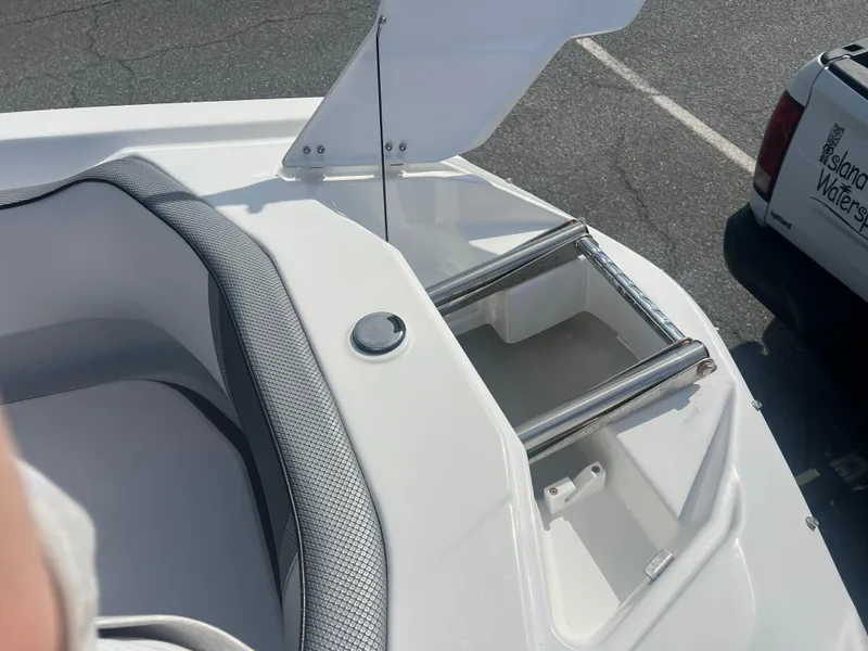 Slide: The Image of 2024 Scarab 255 ID boat with open storage compartment and ladder. - 14