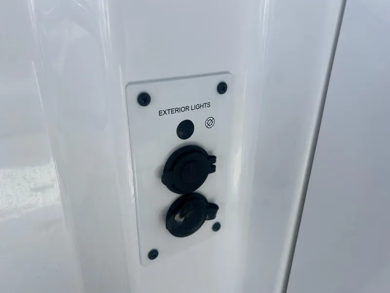 Slide: The Image of Control panel for exterior lights on 2024 Scarab 255 ID boat. - 17