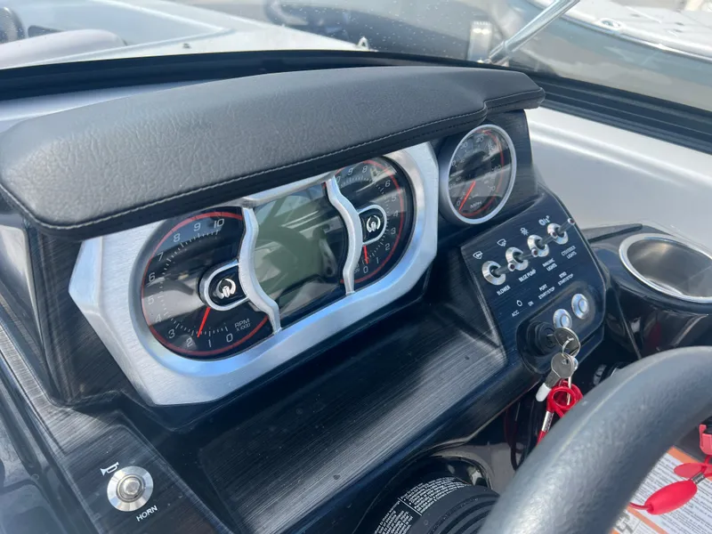 Slide: The Image of Dashboard of a 2024 Scarab 255 ID boat with gauges and controls. - 18