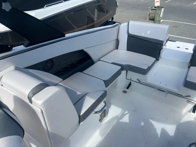 Slide: The Image of 2024 Scarab 255 ID boat interior with sleek white and gray seating. - 20