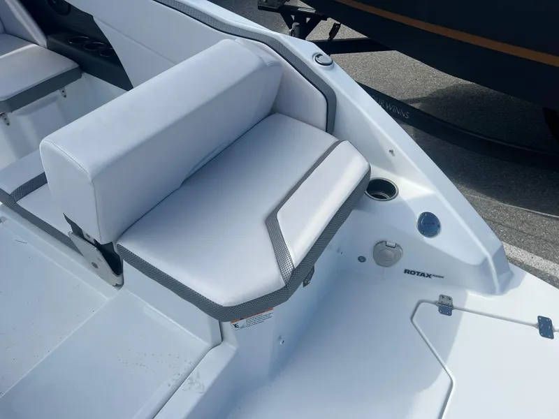 Slide: The Image of 2024 Scarab 255 ID boat interior with white seating and cup holder. - 21