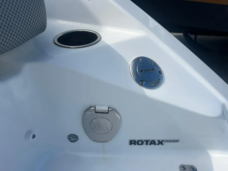 Slide: The Image of 2024 Scarab 255 ID boat detail with Rotax power branding and fuel cap. - 22