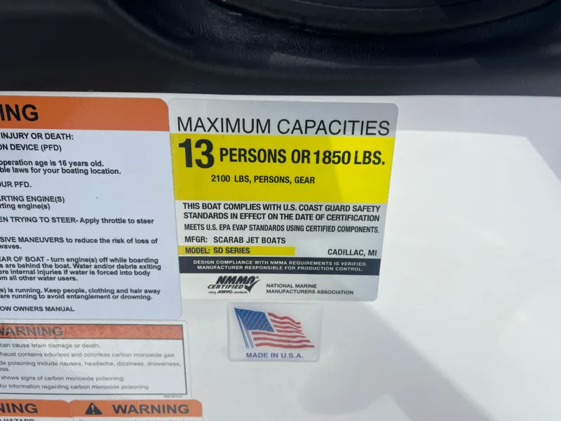 Slide: The Image of 2024 Scarab 255 ID capacity label: 13 persons or 1850 lbs, made in USA. - 24