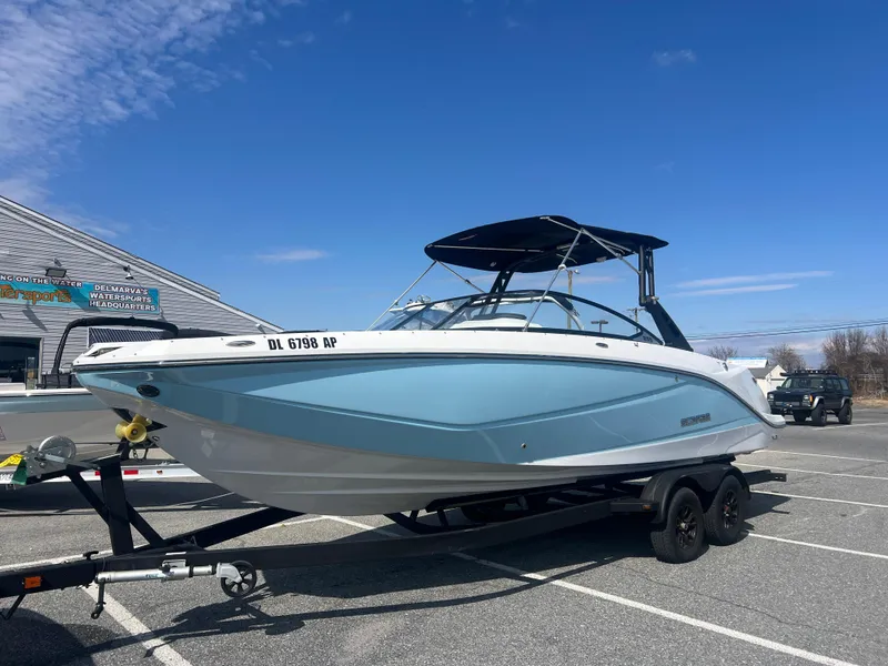 Slide: The Image of 2024 Scarab 255 ID boat on trailer, parked outdoors under clear blue sky. - 4