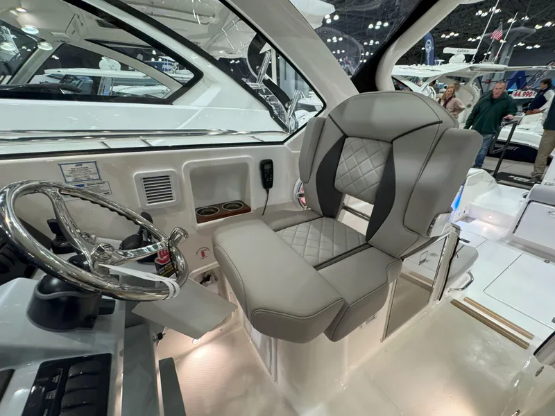 Slide: The Image of 2025 Pursuit OS 325 Offshore helm seat with luxurious design and modern steering wheel. - 17