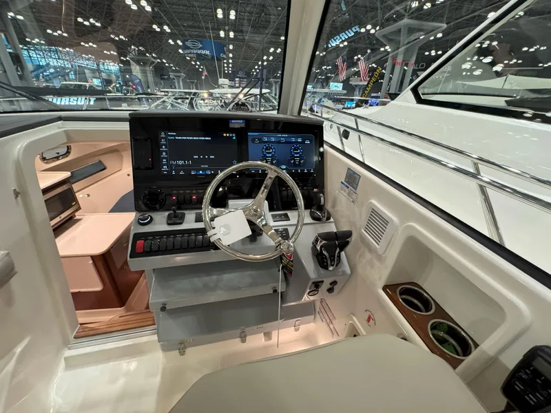 Slide: The Image of 2025 Pursuit OS 325 Offshore helm with modern controls and navigation displays. - 18