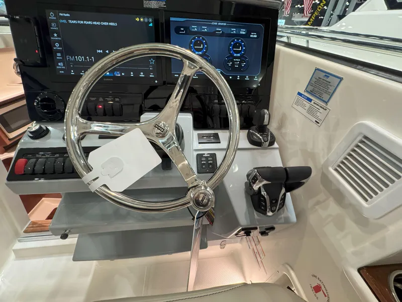 Slide: The Image of Helm of 2025 Pursuit OS 325 Offshore boat with modern controls and displays. - 19