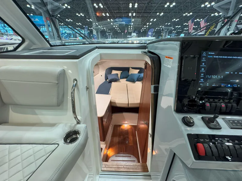Slide: The Image of 2025 Pursuit OS 325 Offshore cabin interior with modern dashboard and cozy sleeping area. - 20