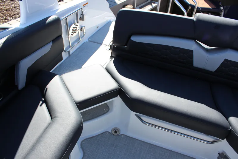 Slide: The Image of 2025 Four Winns HD5 boat interior with black seating and modern design. - 10