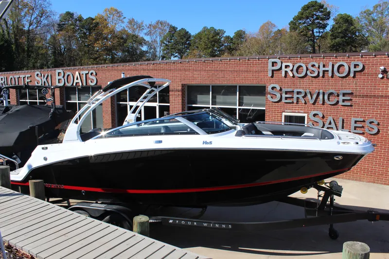 Slide: The Image of 2025 Four Winns HD5 boat displayed at Charlotte Ski Boats dealership. - 5