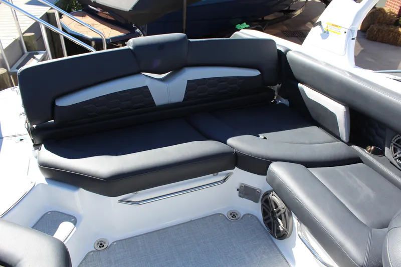 Slide: The Image of 2025 Four Winns HD5 boat interior with sleek black seating and modern design. - 7