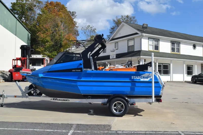Slide: The Image of 2024 Stabicraft 1850 Fisher Sportfish boat on trailer, parked outdoors. - 2
