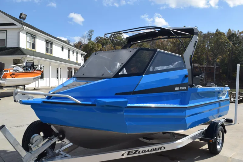 Slide: The Image of 2024 Stabicraft 1850 Fisher Sportfish boat on trailer, vibrant blue color. - 3