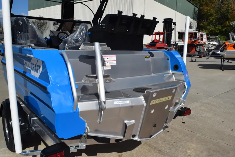 Slide: The Image of 2024 Stabicraft 1850 Fisher Sportfish boat, blue and silver, rear view in outdoor setting. - 4