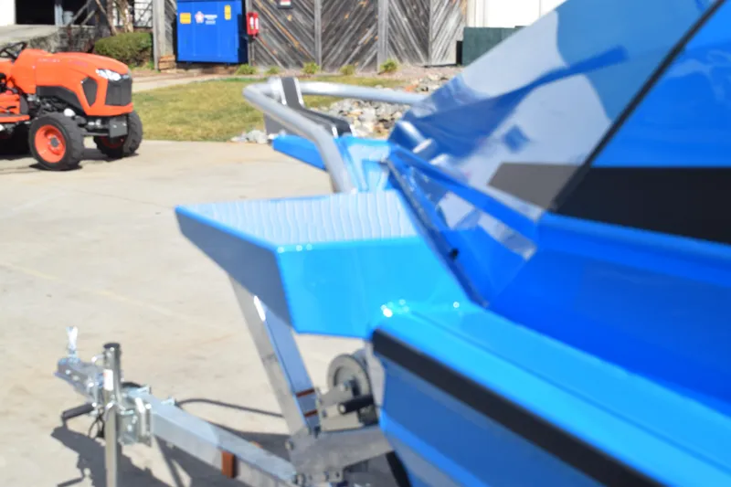 Slide: The Image of 2024 Stabicraft 1850 Fisher Sportfish boat on trailer, with orange tractor in background. - 5