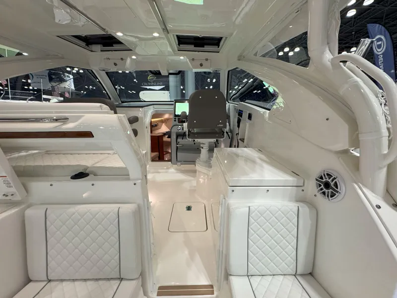 Slide: The Image of Triple Yamaha outboard engines on a 2025 Pursuit OS 405 at a boat show. - 11