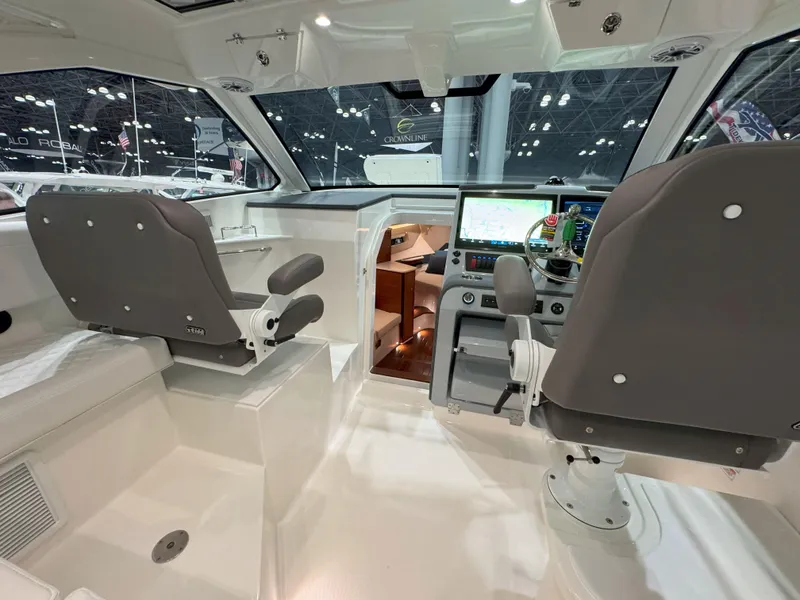Slide: The Image of 2025 Pursuit OS 405 boat interior at a boat show, featuring spacious seating and modern design. - 13